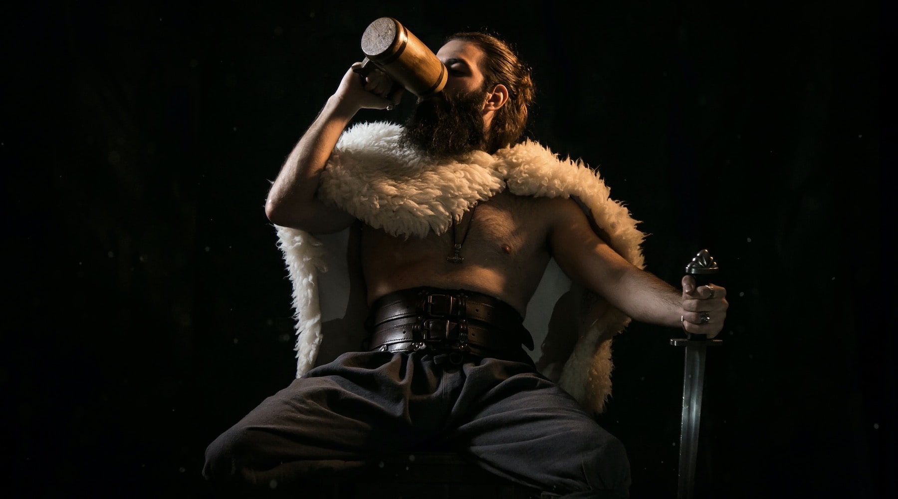 bearded viking sitting and drinking a beer