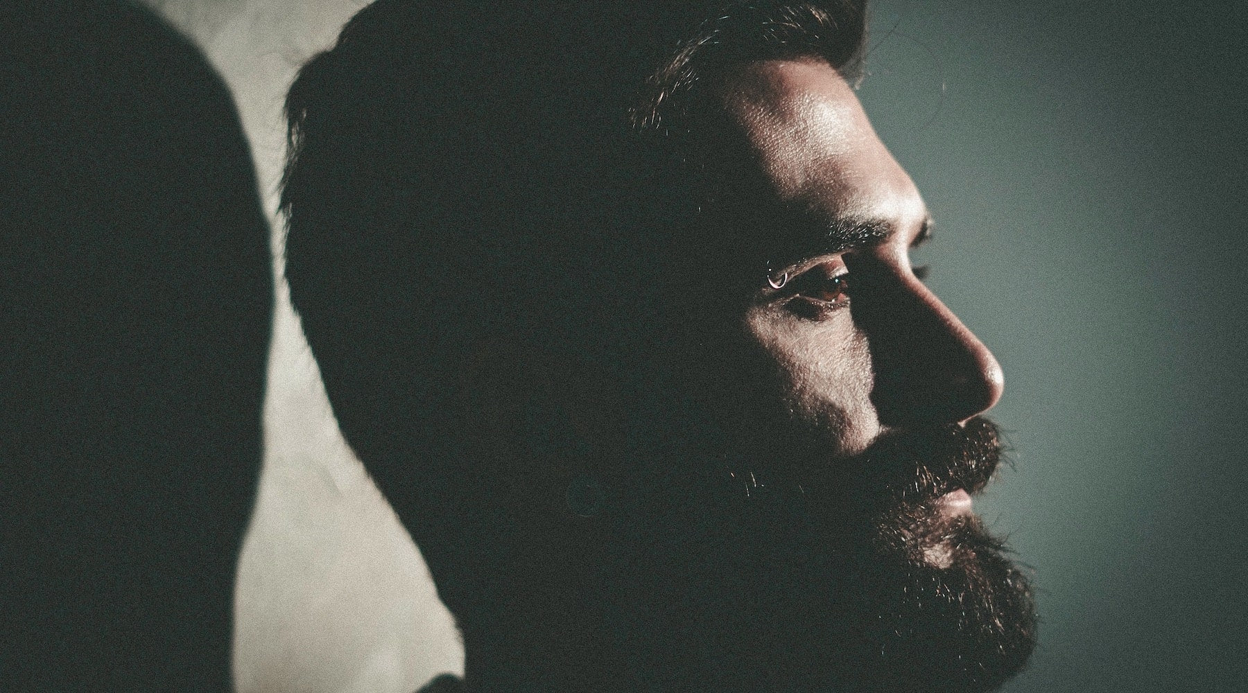 bearded mans face in silhouette