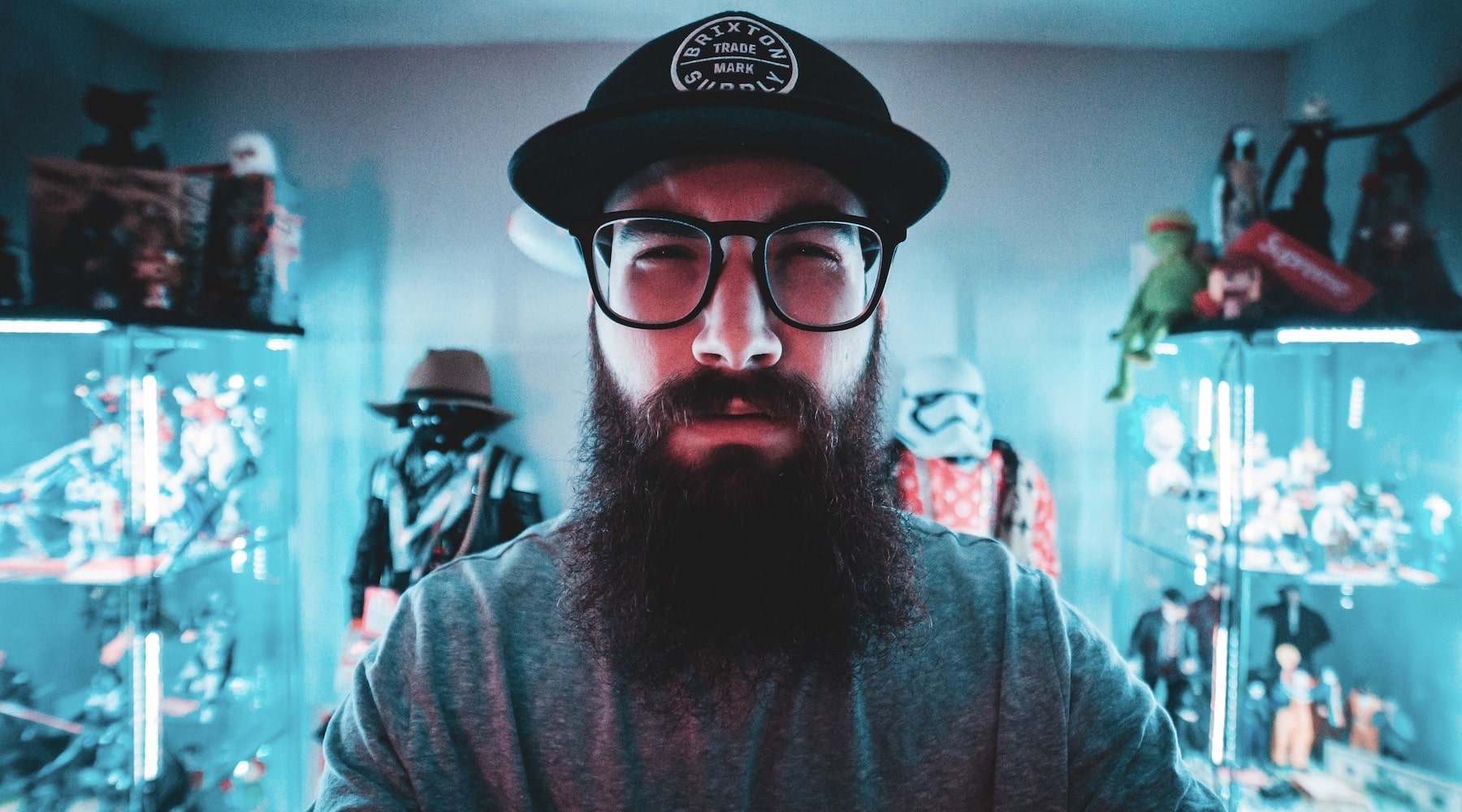 bearded man with a cap looking at a computer
