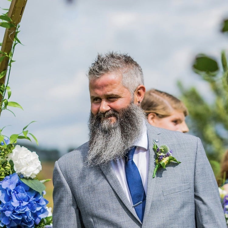 Bearded groom looking happy on his wedding day