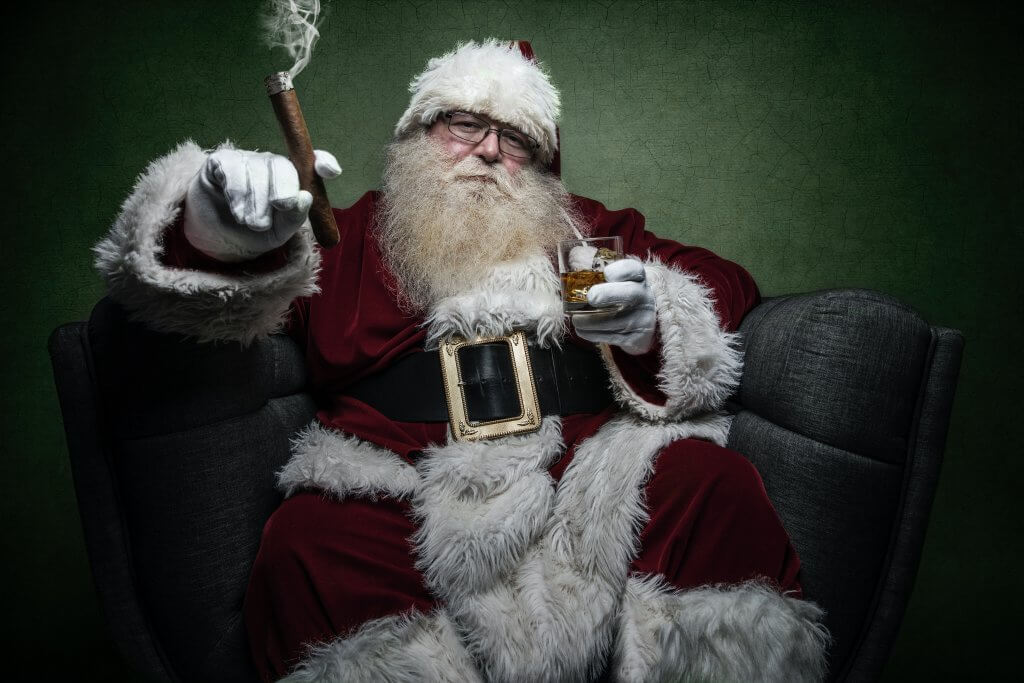 Santa Claus relaxing with a cigar and whiskey